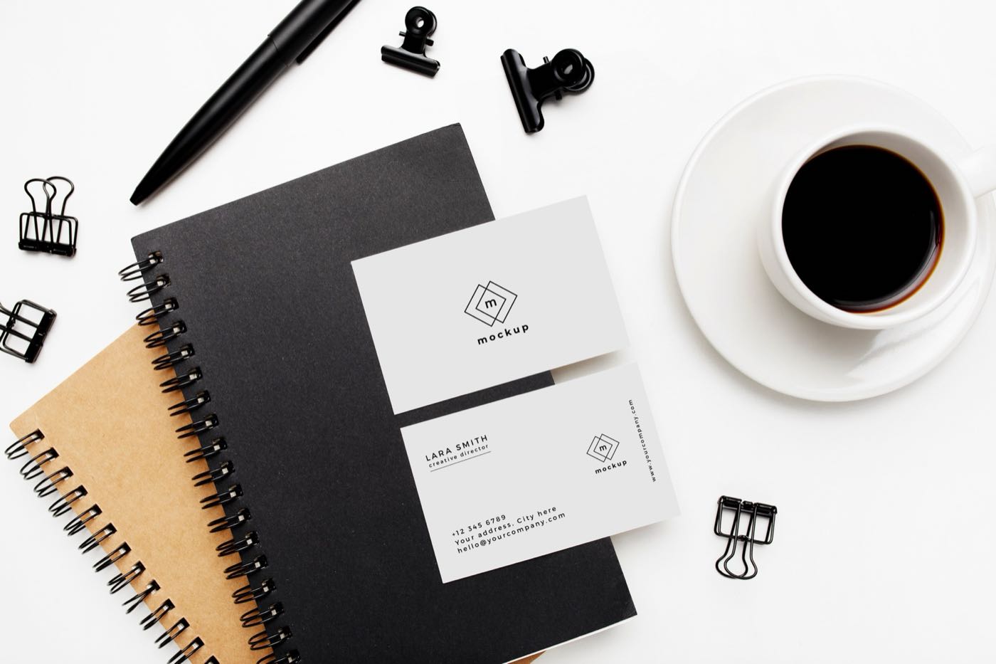 Elegant business cards arranged on a bright white desk