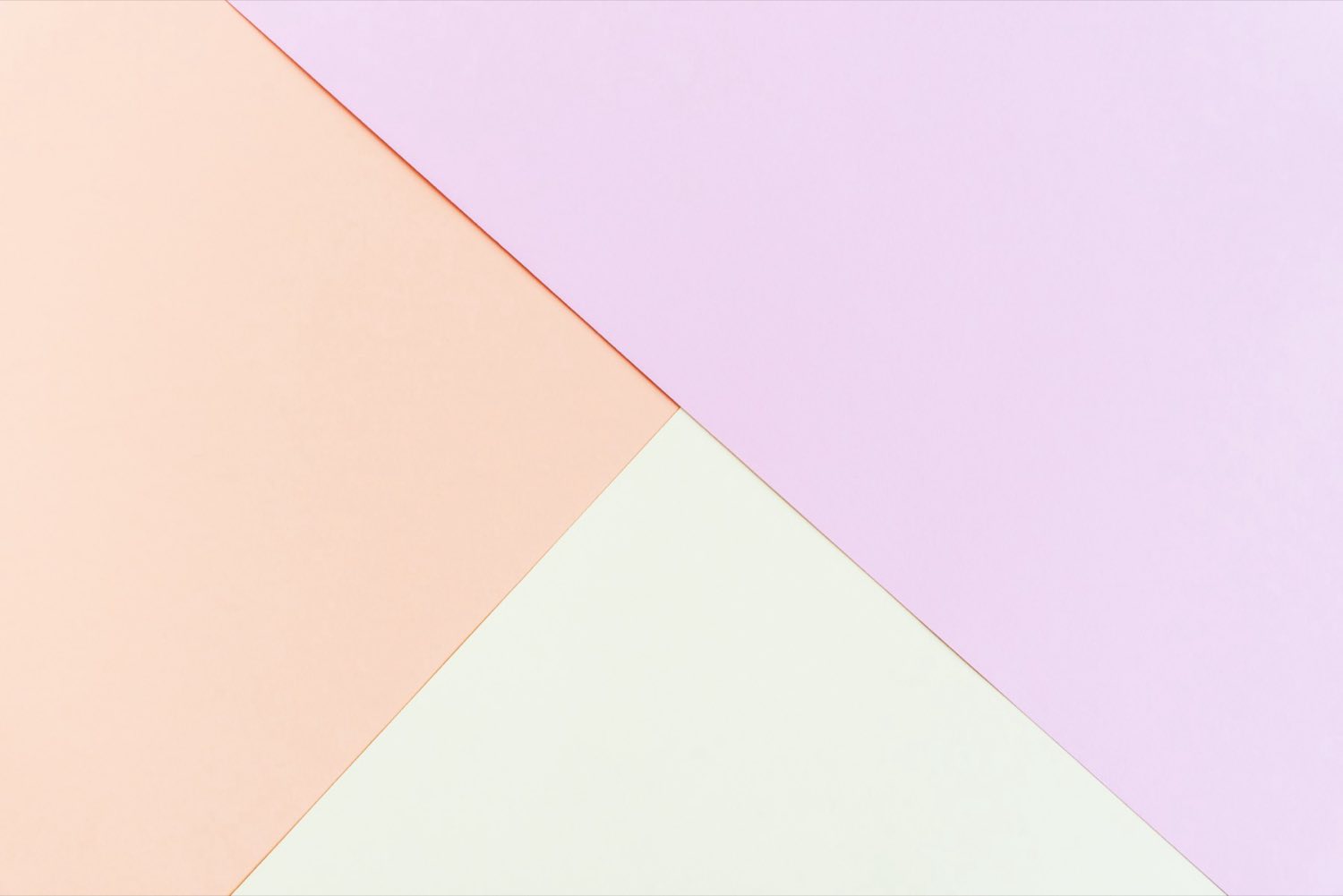 Stacked pastel paper stocks in beige, yellow, and pink